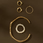 gold jewelry on brown background
