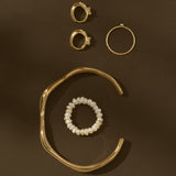 gold jewelry on brown background
