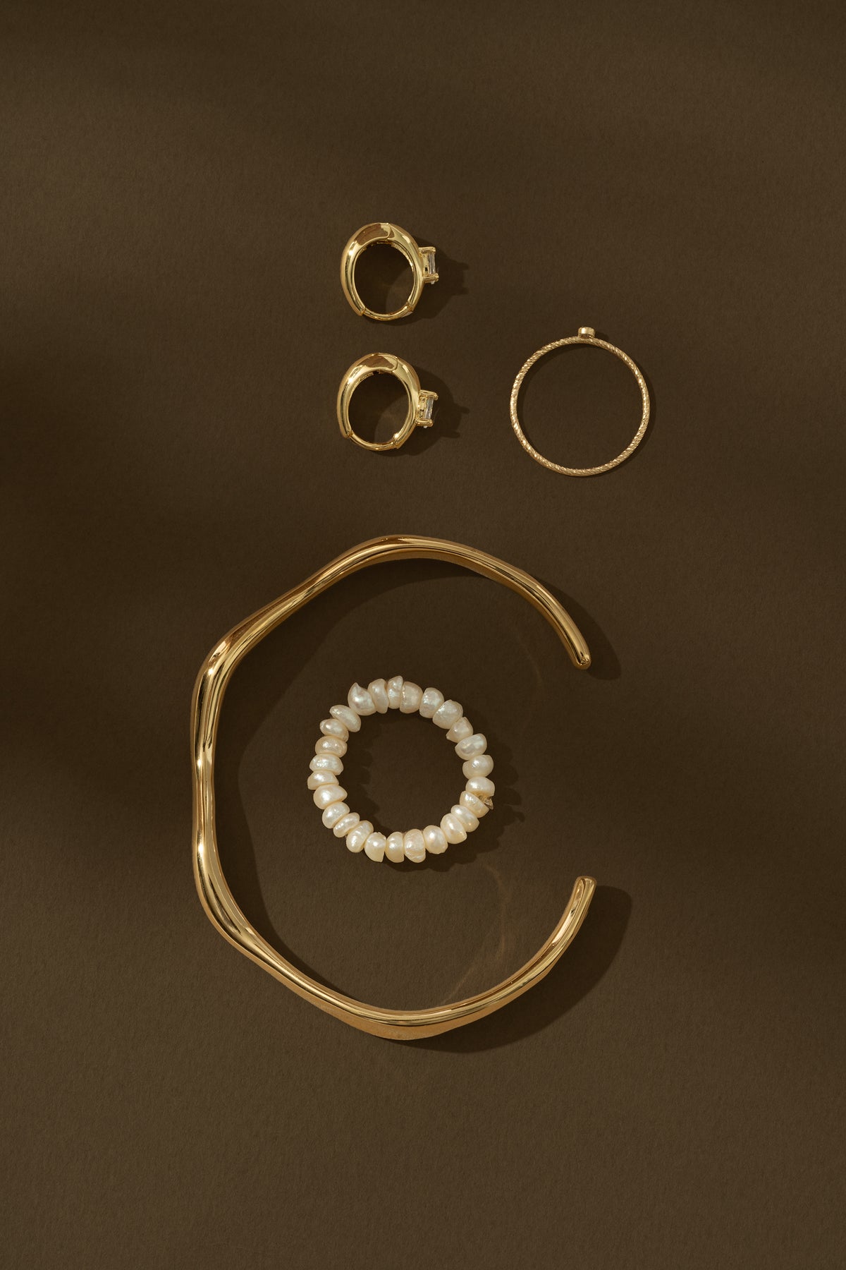 gold jewelry on brown background
