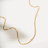 Gold necklace on a light background