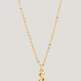 Gold necklace with a 'S' pendant on a light gray background