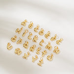 Gold letter charms on a white background