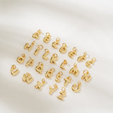 Gold letter charms on a white background