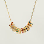 Necklace with birthstone charmon a light gray background