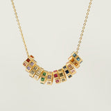Necklace with birthstone charmon a light gray background