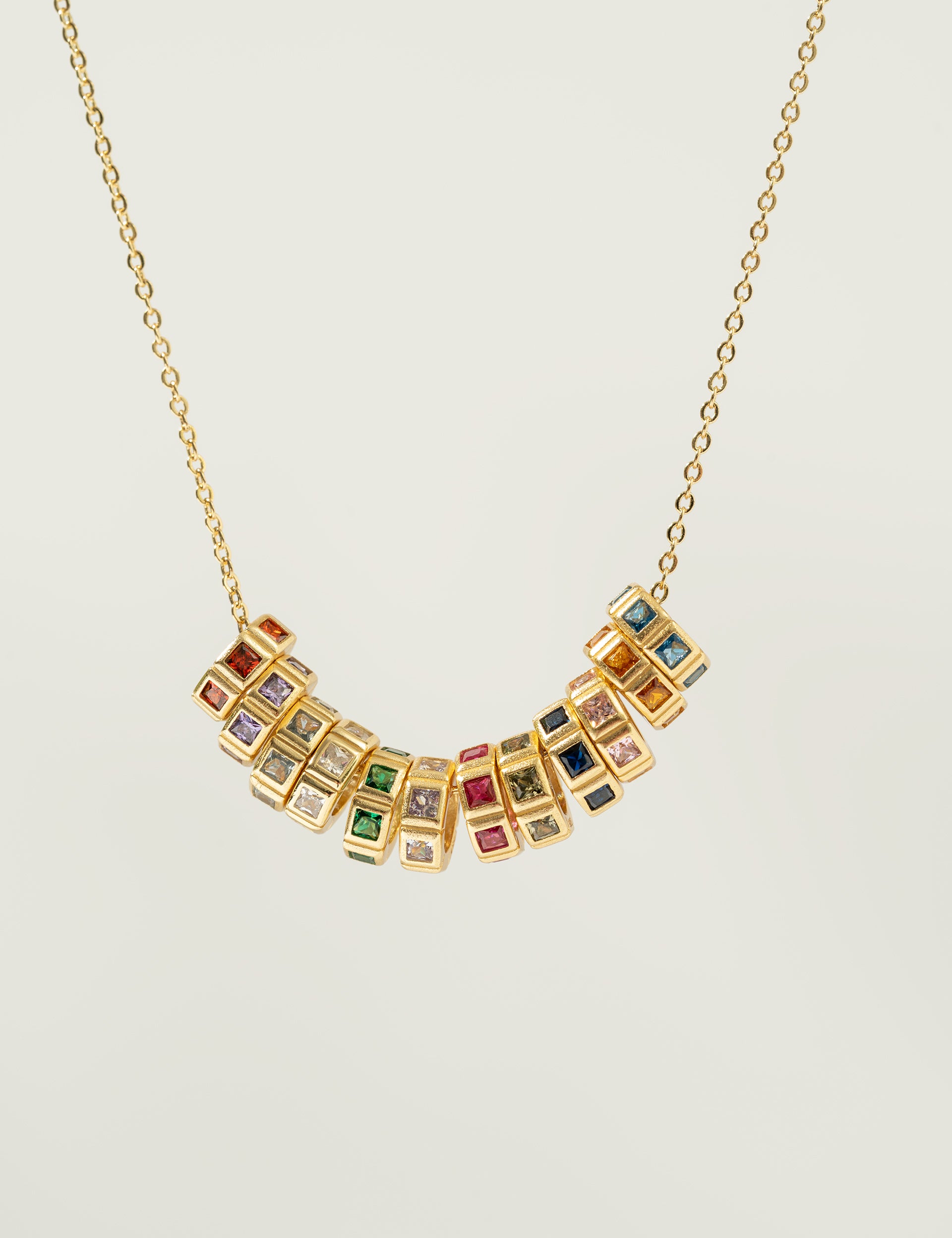 Necklace with birthstone charmon a light gray background