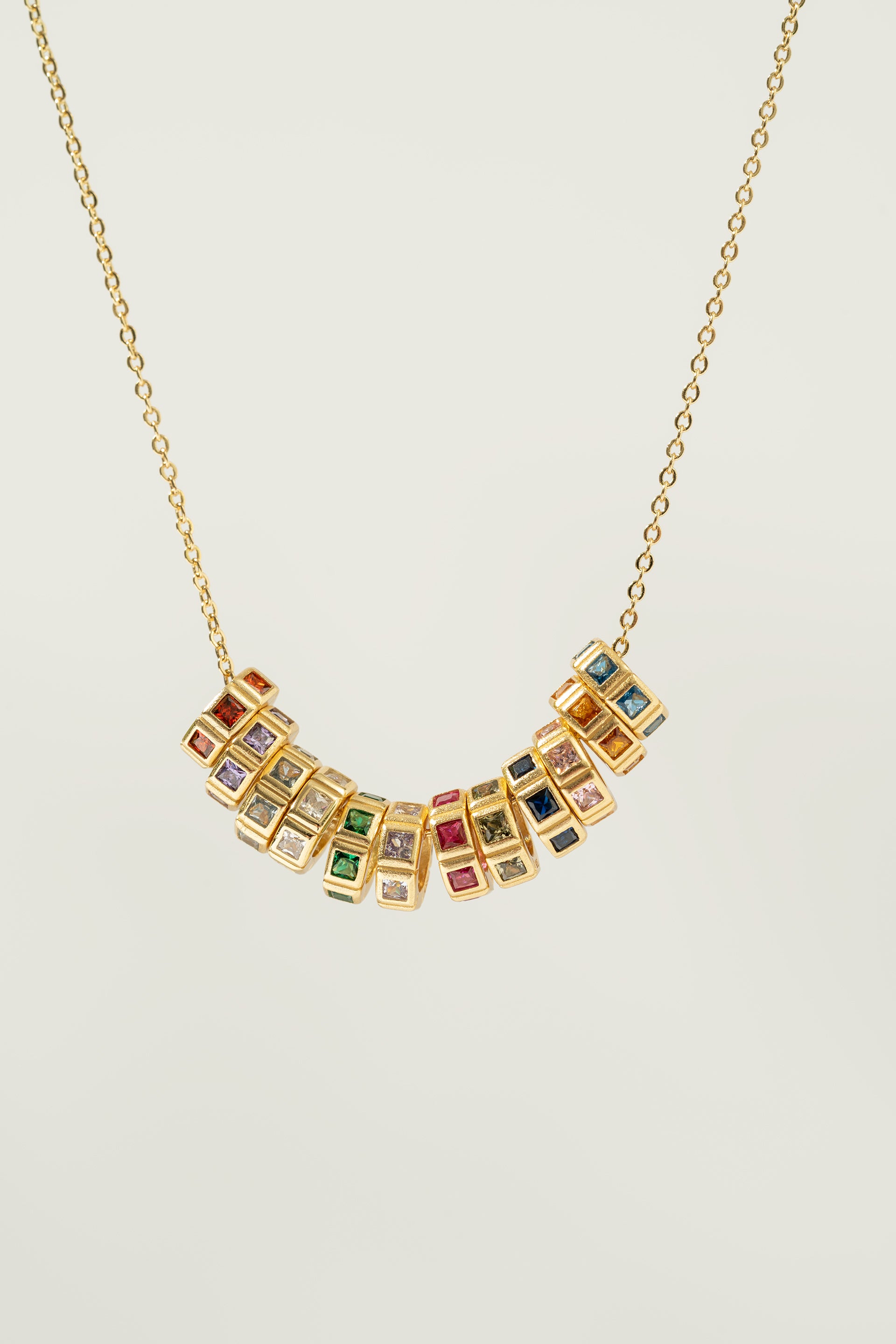 Necklace with birthstone charmon a light gray background