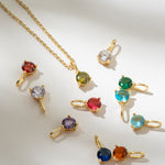 Gold necklaces with multicolored gemstones on a white background
