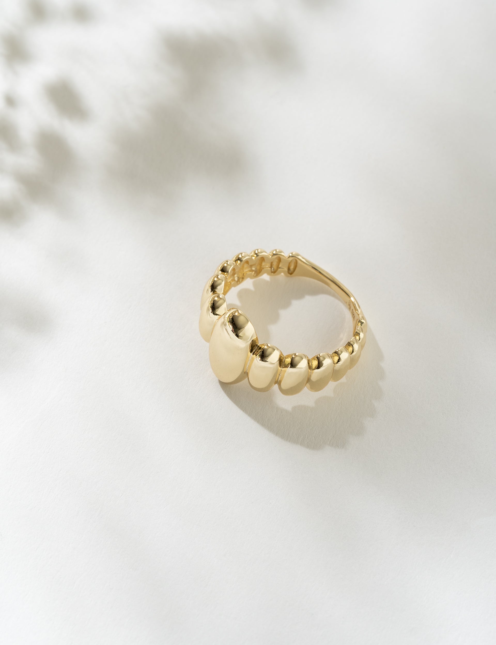 Gold ring on a light background