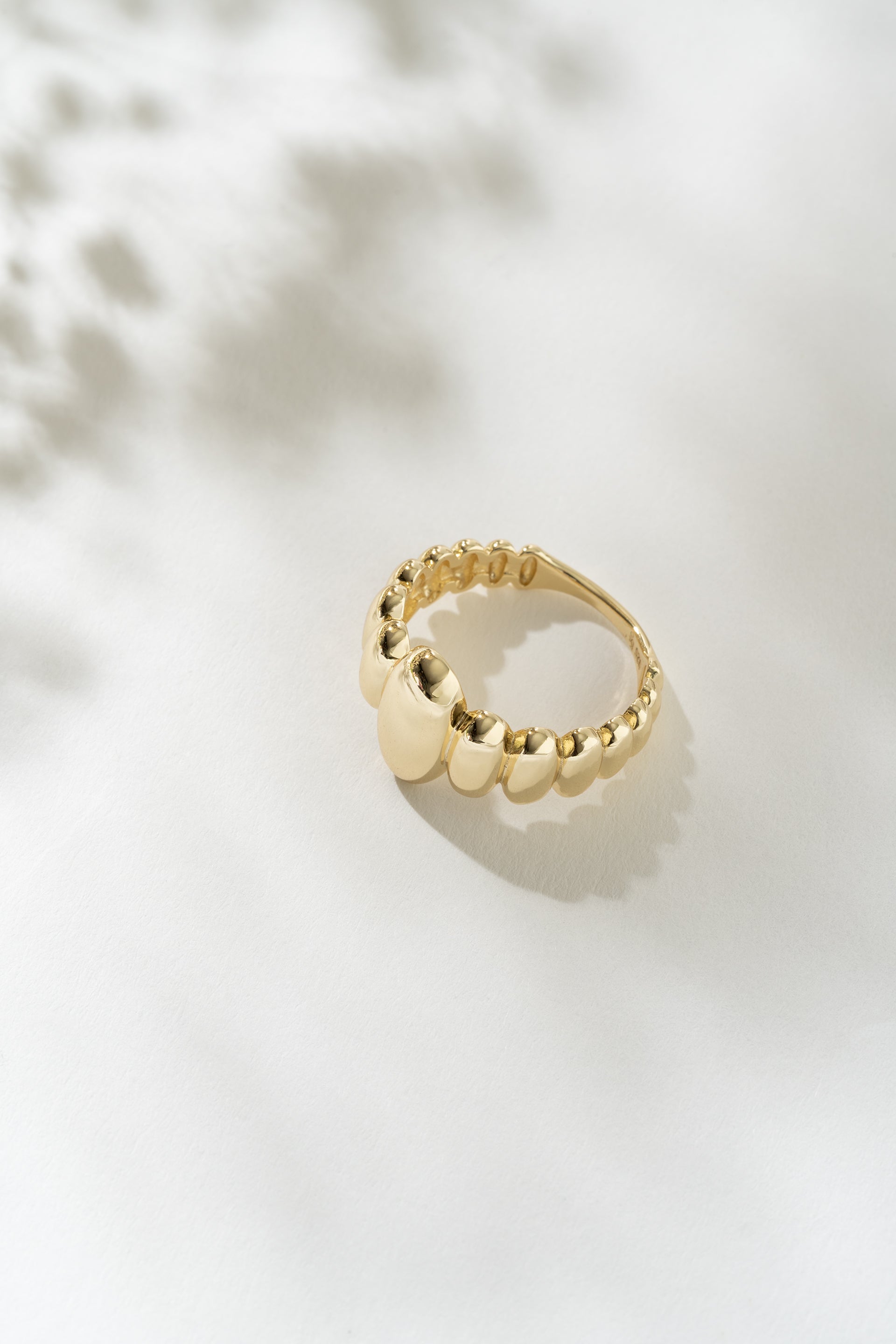 Gold ring on a light background
