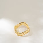 Gold ring on a light gray background