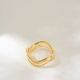 Gold ring on a light gray background