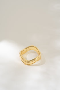 Gold ring on a light gray background