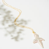 Gold necklace with a pearl cross pendant