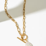 Gold necklace with a pearl pendant on a white background