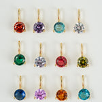 Set of colorful gemstone earrings on a white background