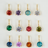 Set of colorful gemstone earrings on a white background
