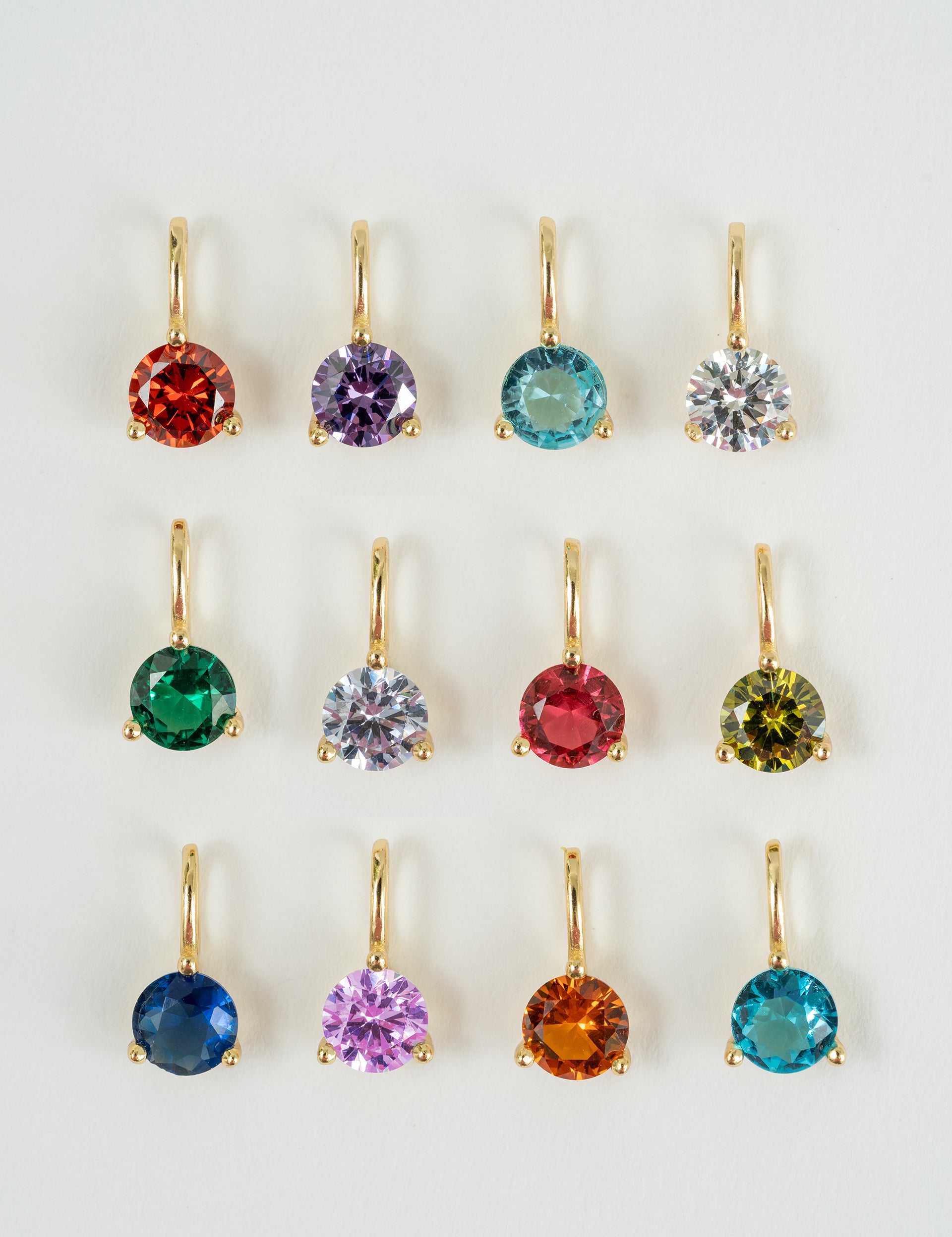 Set of colorful gemstone earrings on a white background