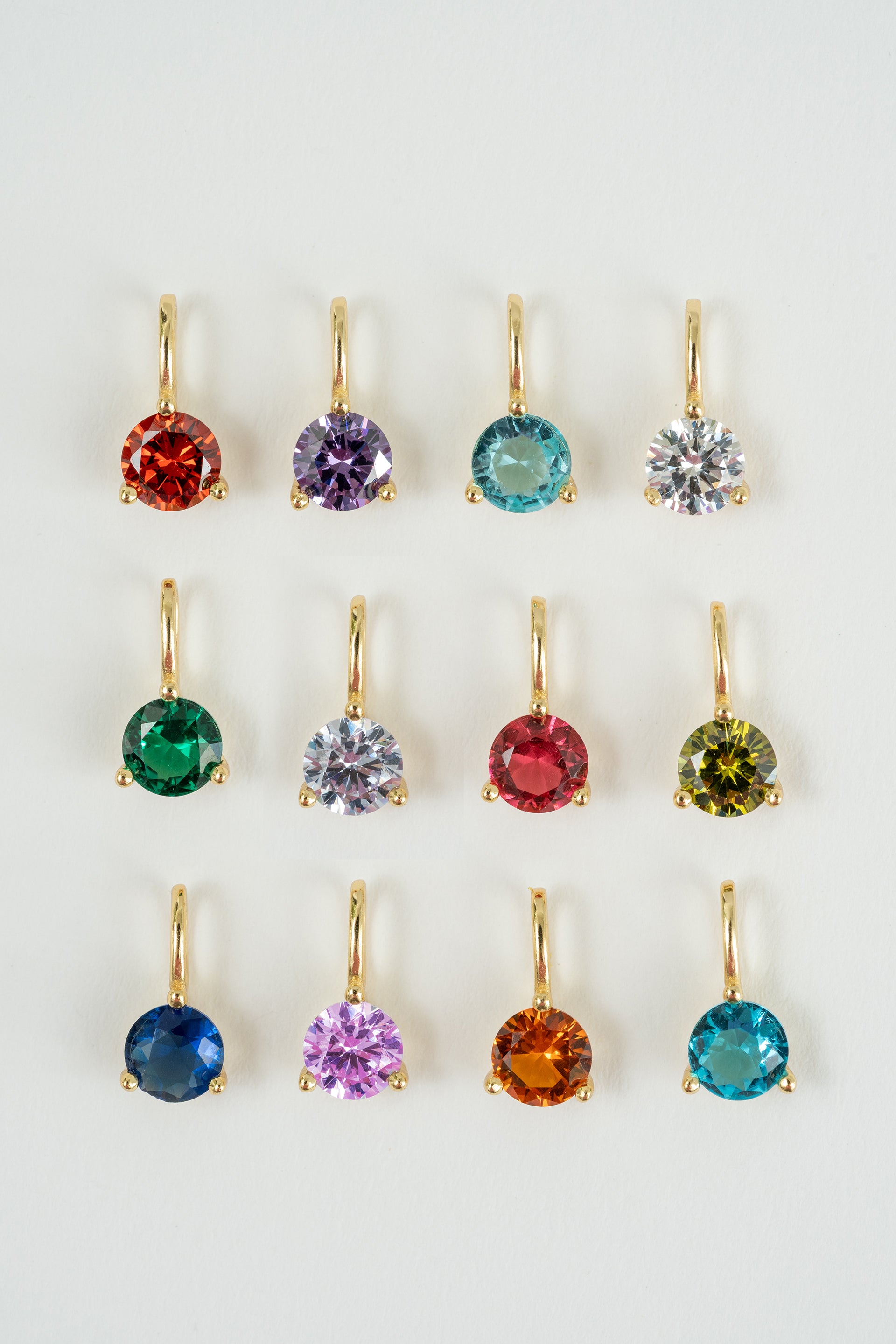 Set of colorful gemstone earrings on a white background