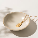 Close-up of the Olivia Necklace showcasing its intricate olive branch design in 18kt gold stainless steel. The fine detailing and warm gold tone create a timeless, elegant piece perfect for everyday wear or special occasions.