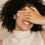 woman smiling with gold filled jewelry
