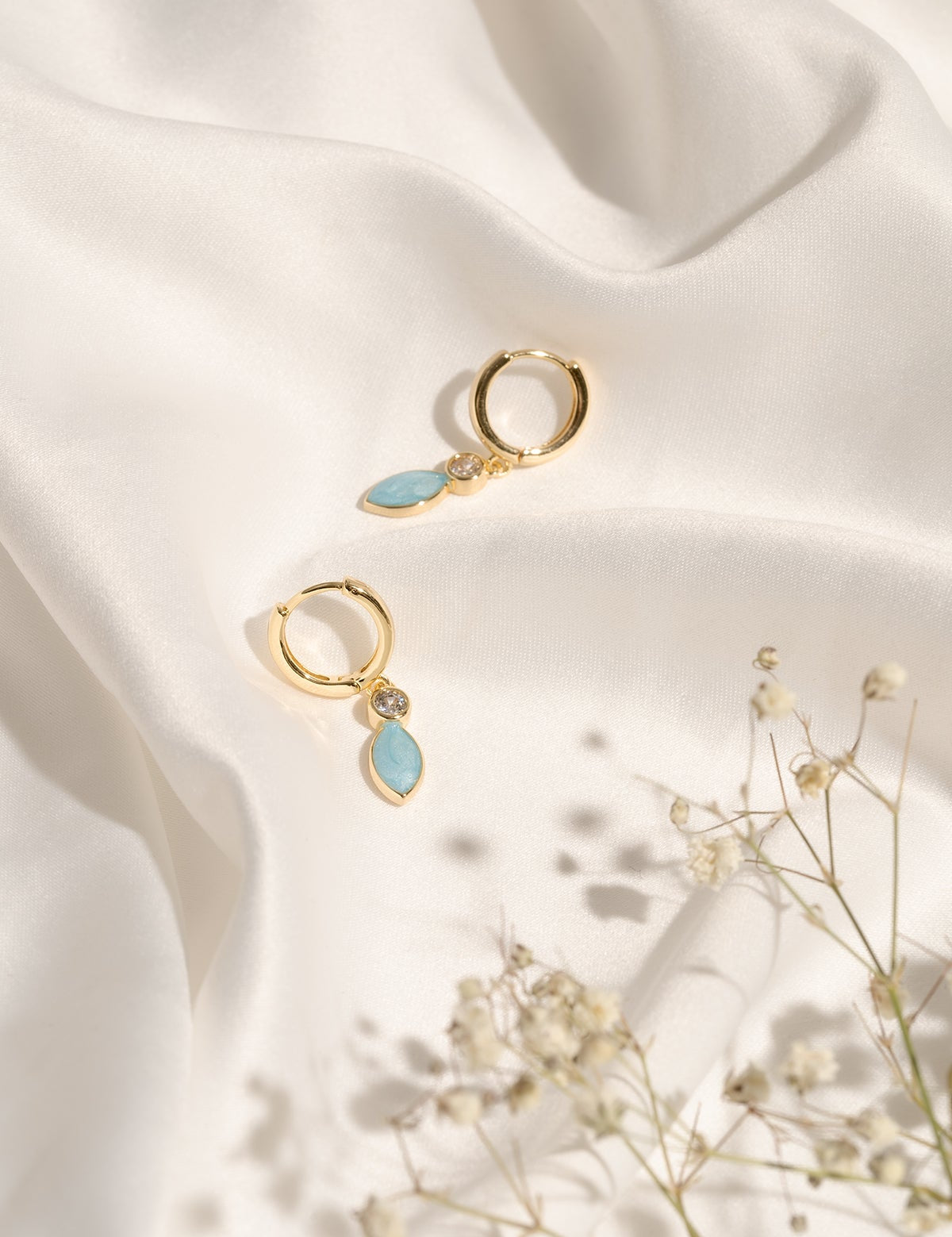 Pair of Christine Earrings showcasing their small hoop shape and colourful enamel finish.
