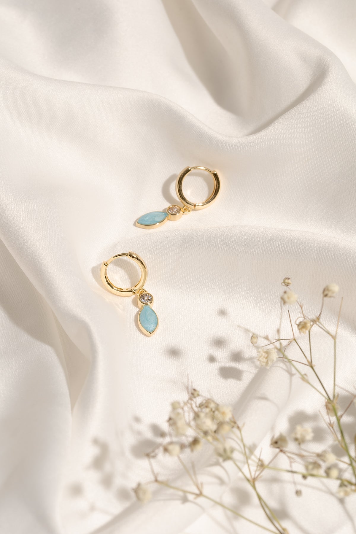 Pair of Christine Earrings showcasing their small hoop shape and colourful enamel finish.