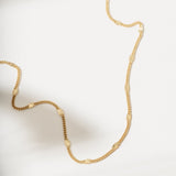 Gold necklace on a light background