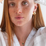 Person wearing a white shirt with a plain background