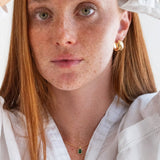 Person wearing a white shirt with a plain background