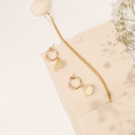 Close-up of the Alana Necklace highlighting its seashell pendant and gold chain.