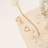 Close-up of the Alana Necklace highlighting its seashell pendant and gold chain.