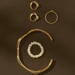 gold jewelry on brown background
